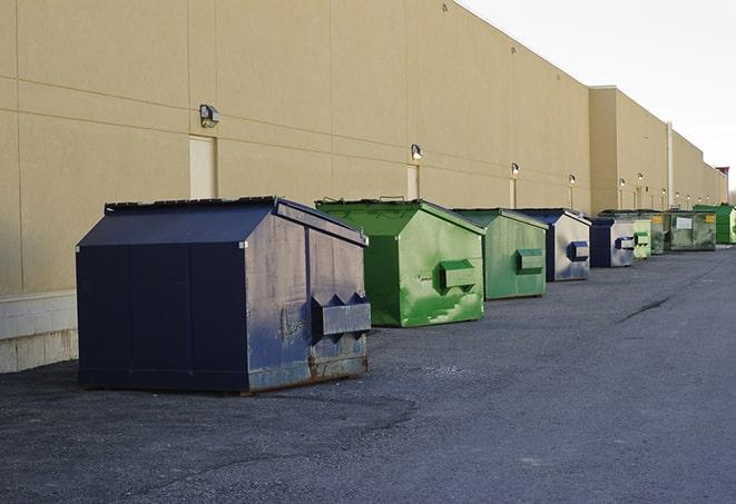 a fleet of red and blue construction dumpsters available for use in Osprey FL